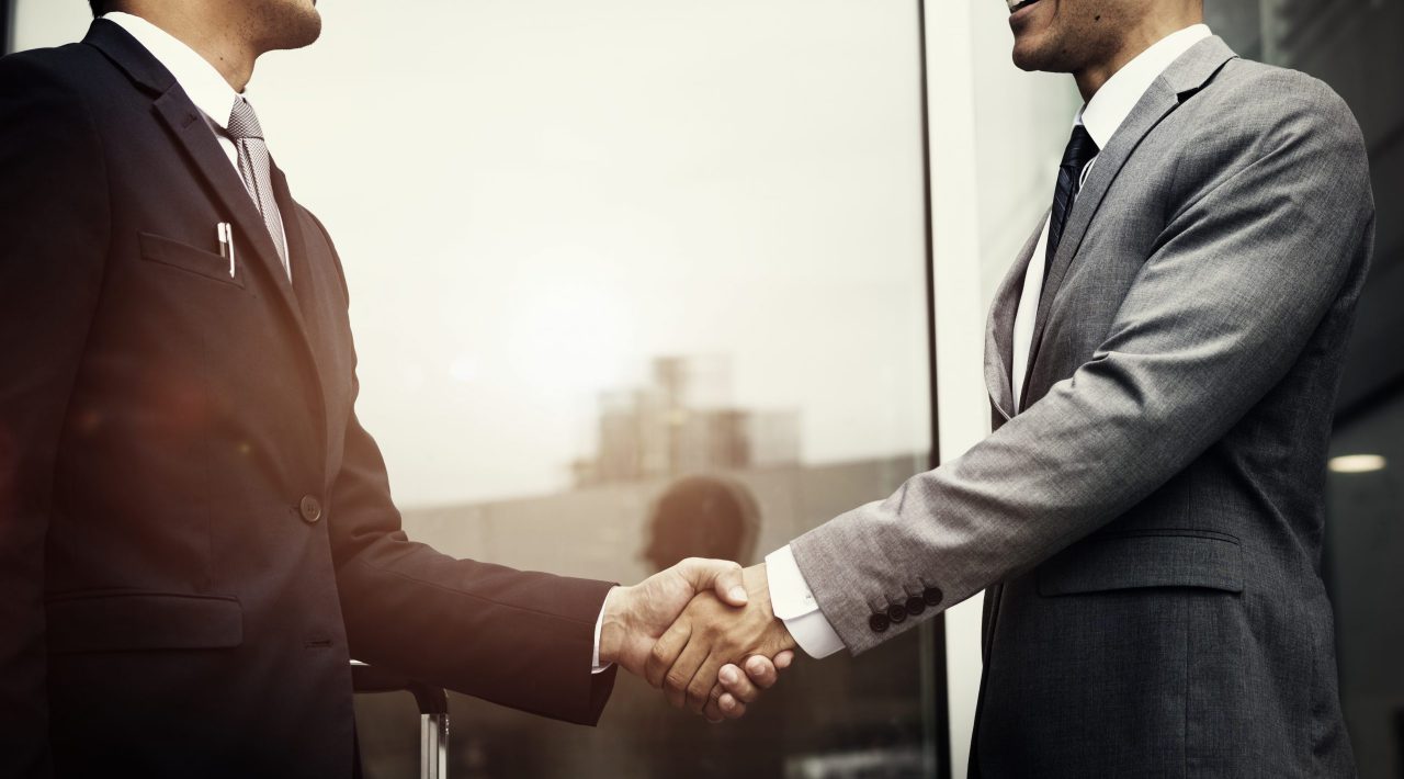 Corporate businessmen shaking hands